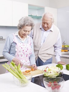 senior couple preparing meal in kitchen